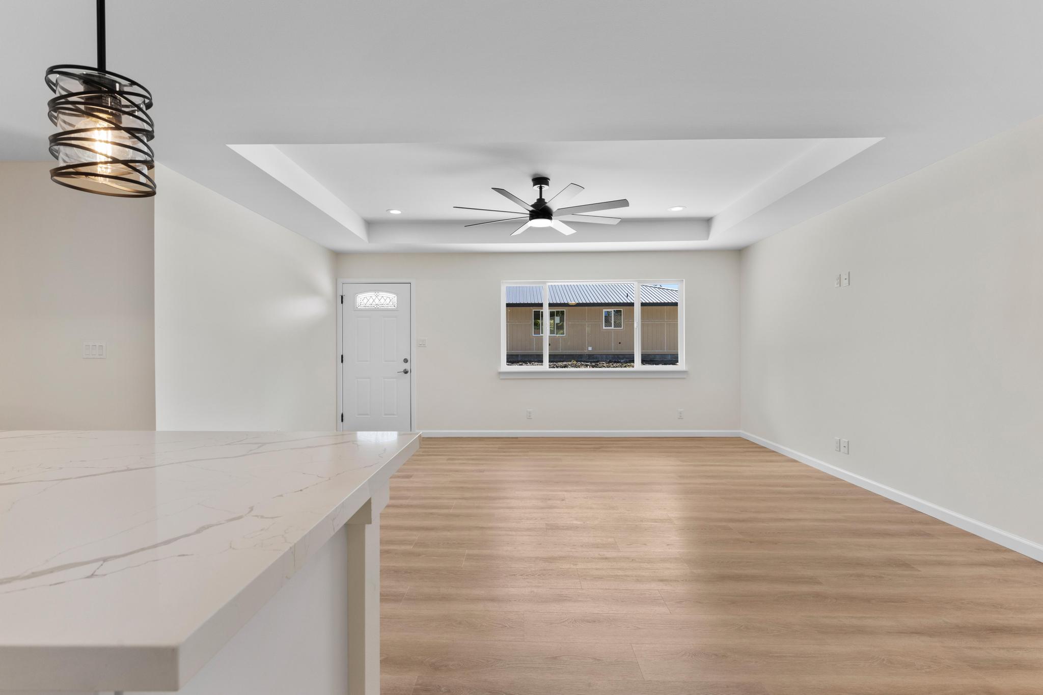 16-2579 Ainaloa Drive Pahoa, HI 96778 - Photo 22 of 30 a view of an empty room with wooden floor and a window