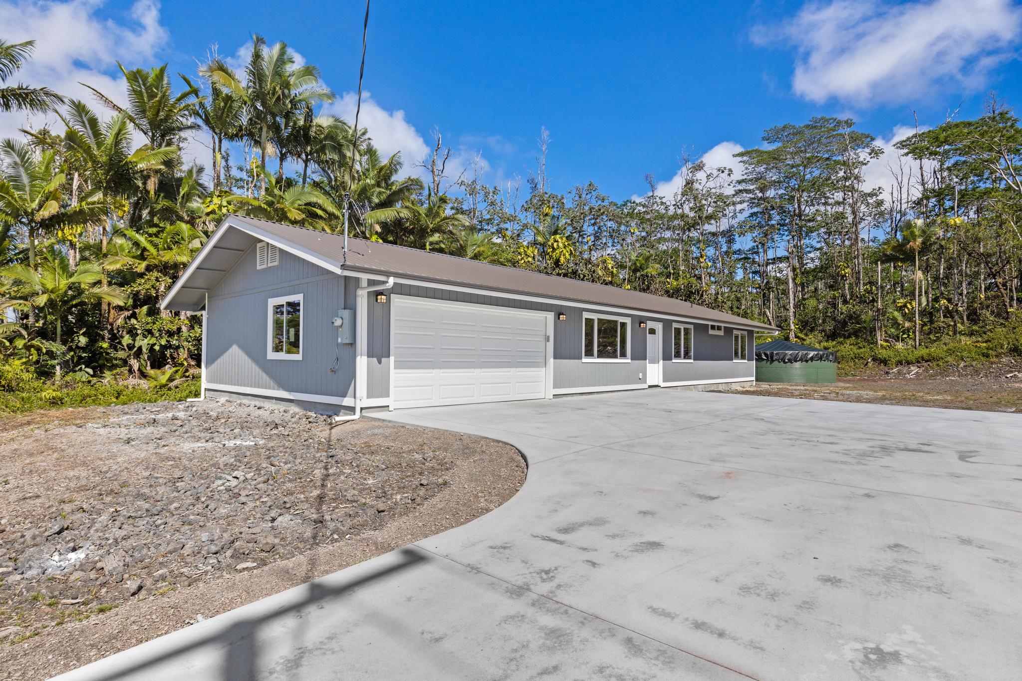 16-2579 Ainaloa Drive Pahoa, HI 96778 - Photo 29 of 30 a front view of house with yard and trees in the background
