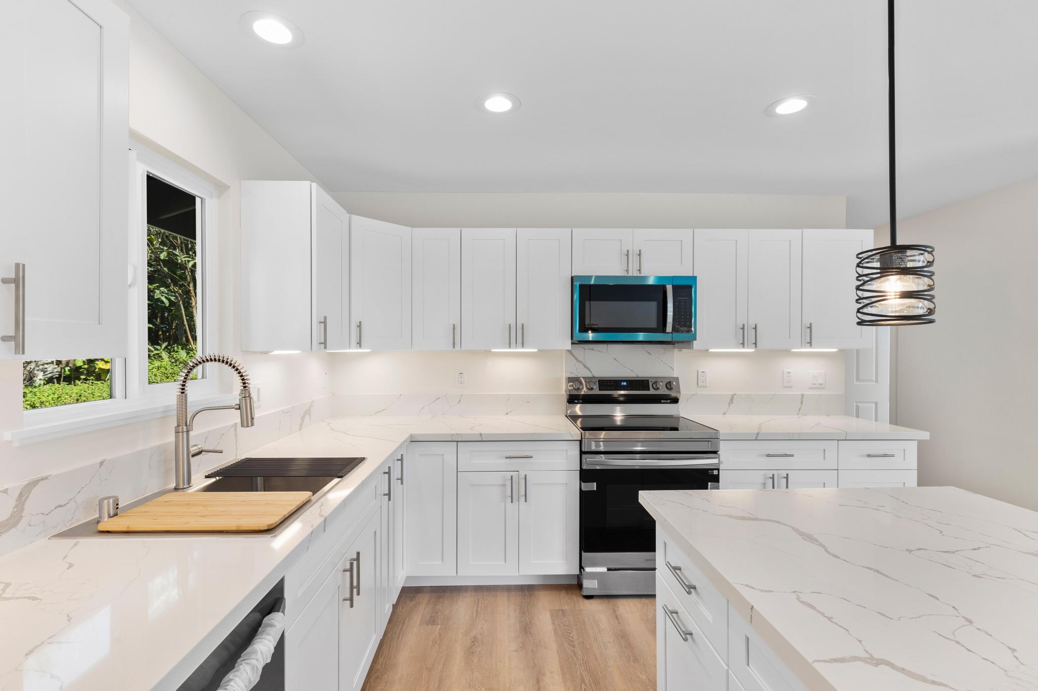 16-2579 Ainaloa Drive Pahoa, HI 96778 - Photo 3 of 30 a kitchen with a sink stove top oven and refrigerator