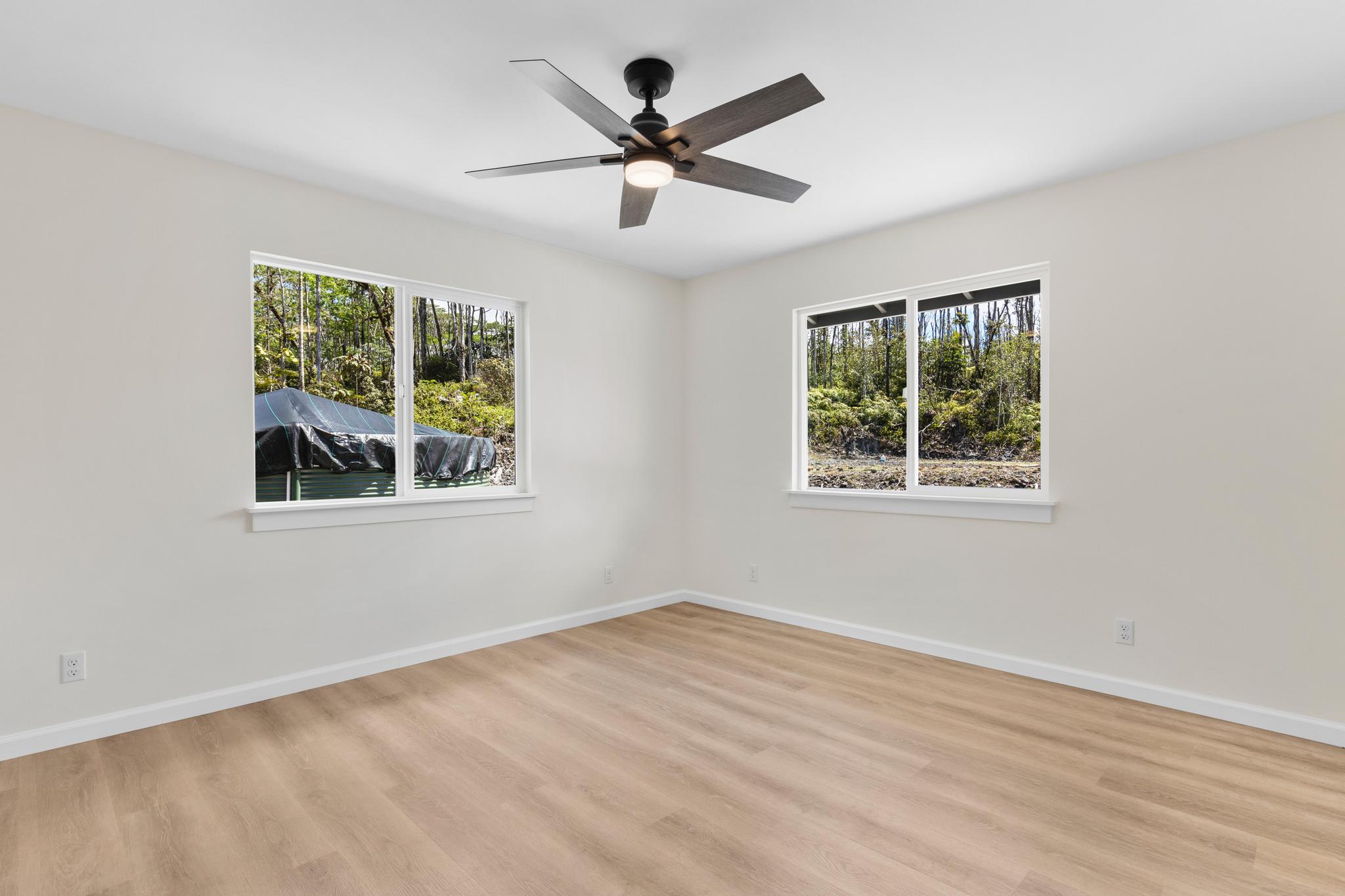 16-2579 Ainaloa Drive Pahoa, HI 96778 - Photo 7 of 30 a view of empty room with wooden floor and fan
