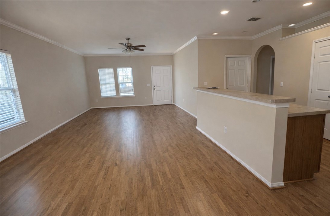 1022 Livermore Street Portland, TX 78374 - Photo 2 of 14 an empty room with wooden floor and windows