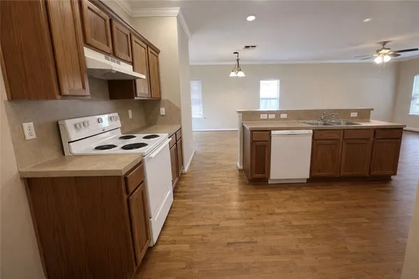 a kitchen with kitchen island a sink appliances and cabinets