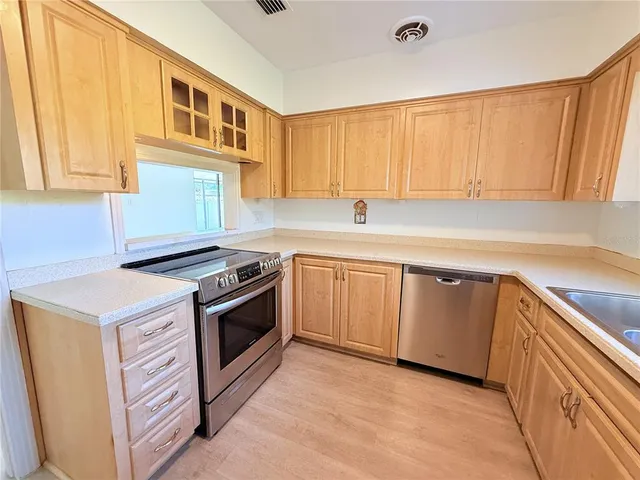 a kitchen with a sink stove and cabinets