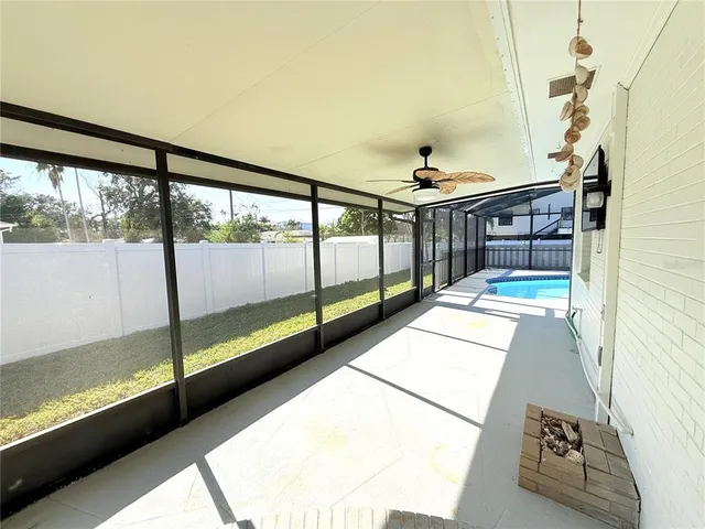 a living room with stainless steel appliances kitchen island furniture and a flat screen tv