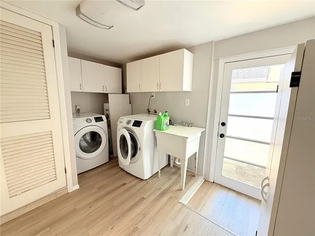 a bathroom with a tub a sink and a mirror