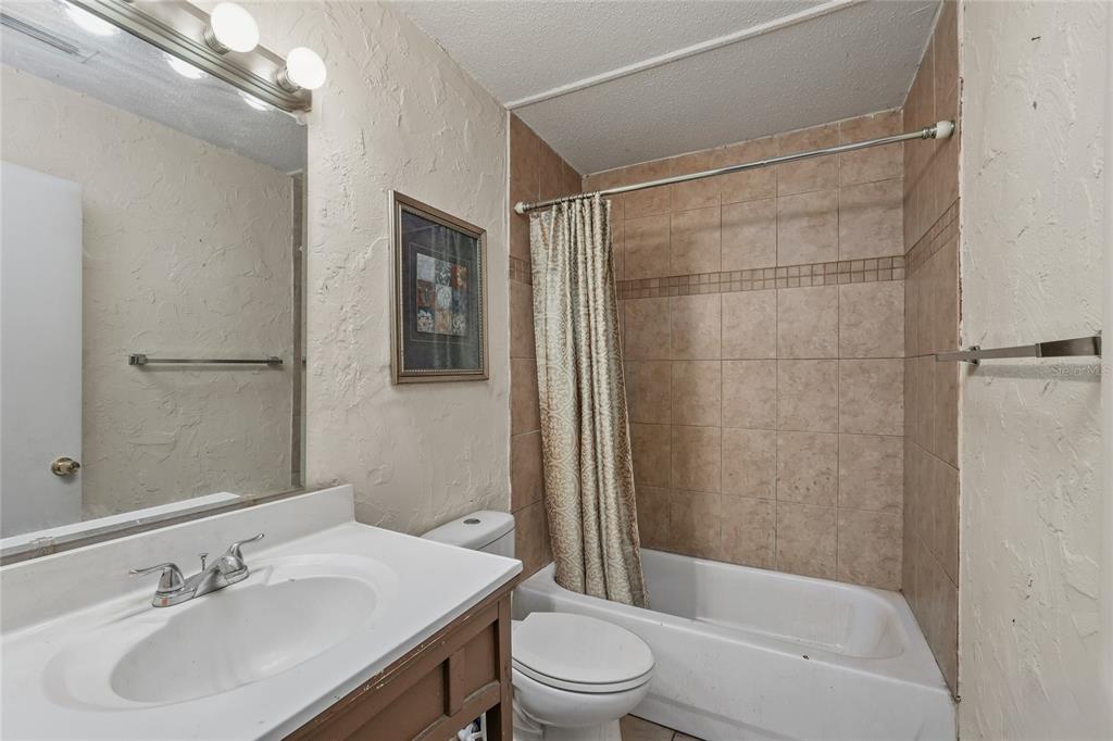 1432 Windmill Pointe Road Palm Harbor, FL 34685 - Photo 13 of 44 a bathroom with a sink toilet and shower