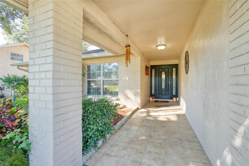 1432 Windmill Pointe Road Palm Harbor, FL 34685 - Photo 15 of 44 a view of a house with a backyard and garden