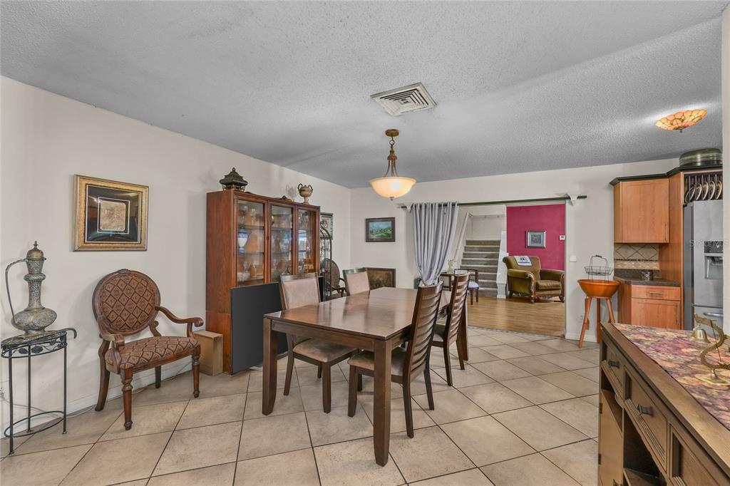 1432 Windmill Pointe Road Palm Harbor, FL 34685 - Photo 17 of 44 a view of a dining room with furniture and chandelier