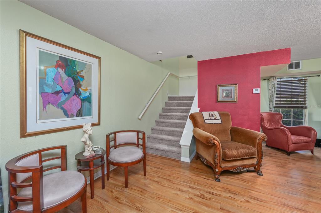 1432 Windmill Pointe Road Palm Harbor, FL 34685 - Photo 18 of 44 a living room with furniture and a wooden floor