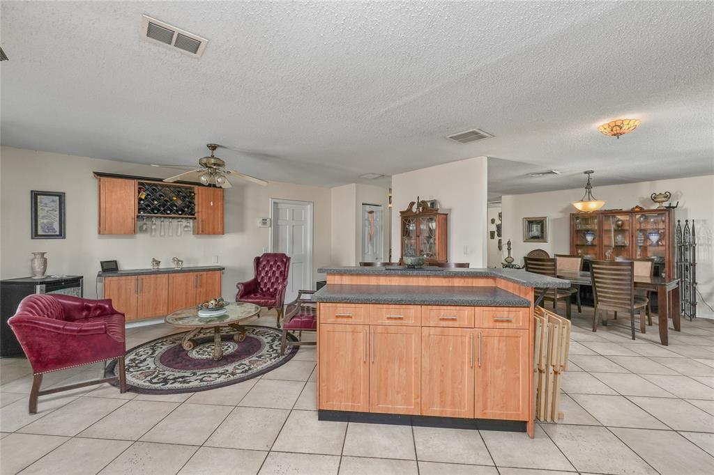 1432 Windmill Pointe Road Palm Harbor, FL 34685 - Photo 20 of 44 a living room with furniture a table and a fireplace
