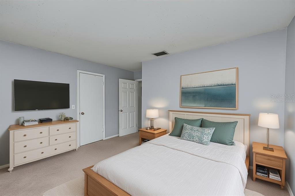 1432 Windmill Pointe Road Palm Harbor, FL 34685 - Photo 2 of 44 a bedroom with a bed and a television in it