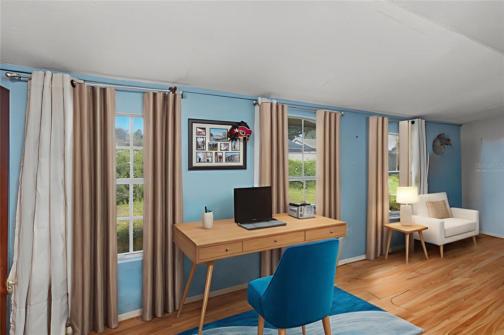 1432 Windmill Pointe Road Palm Harbor, FL 34685 - Photo 3 of 44 a living room with furniture and a window