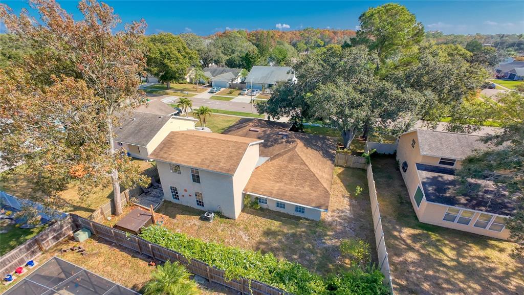 1432 Windmill Pointe Road Palm Harbor, FL 34685 - Photo 43 of 44 an aerial view of a house with swimming pool a yard and a large tree
