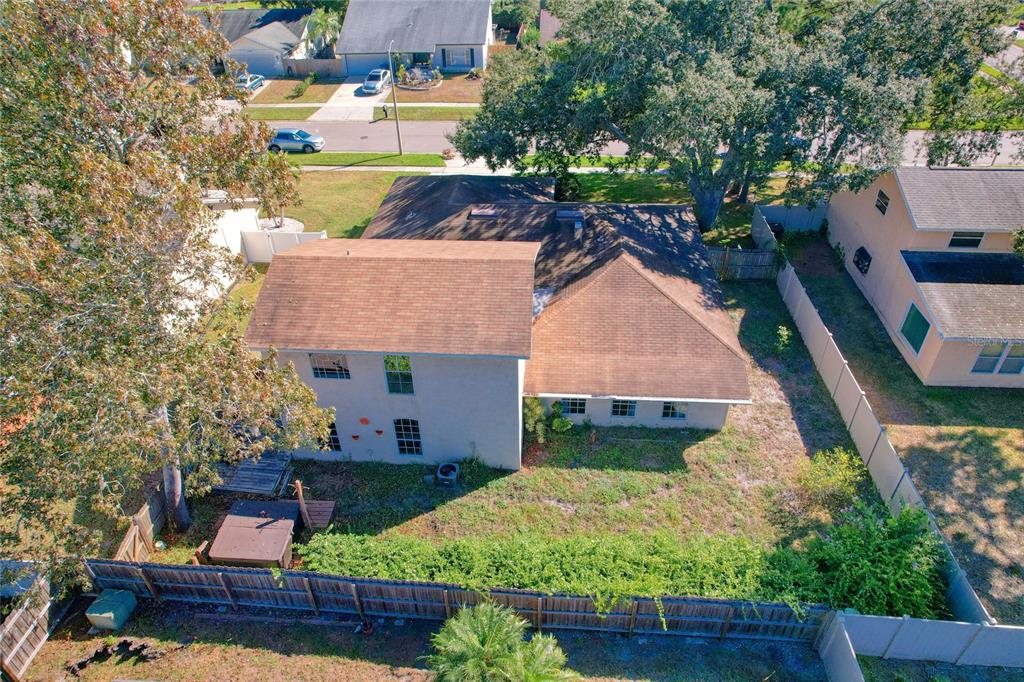 1432 Windmill Pointe Road Palm Harbor, FL 34685 - Photo 5 of 44 an aerial view of a house with a garden and large trees