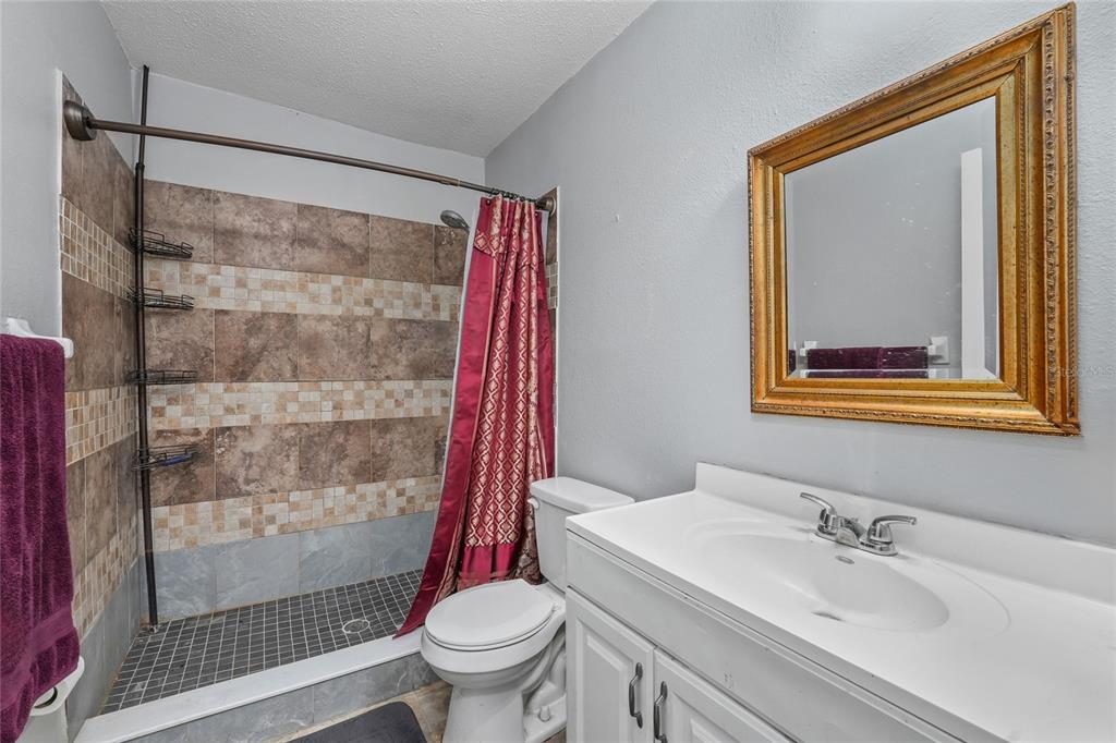 1432 Windmill Pointe Road Palm Harbor, FL 34685 - Photo 8 of 44 a bathroom with a sink toilet and shower