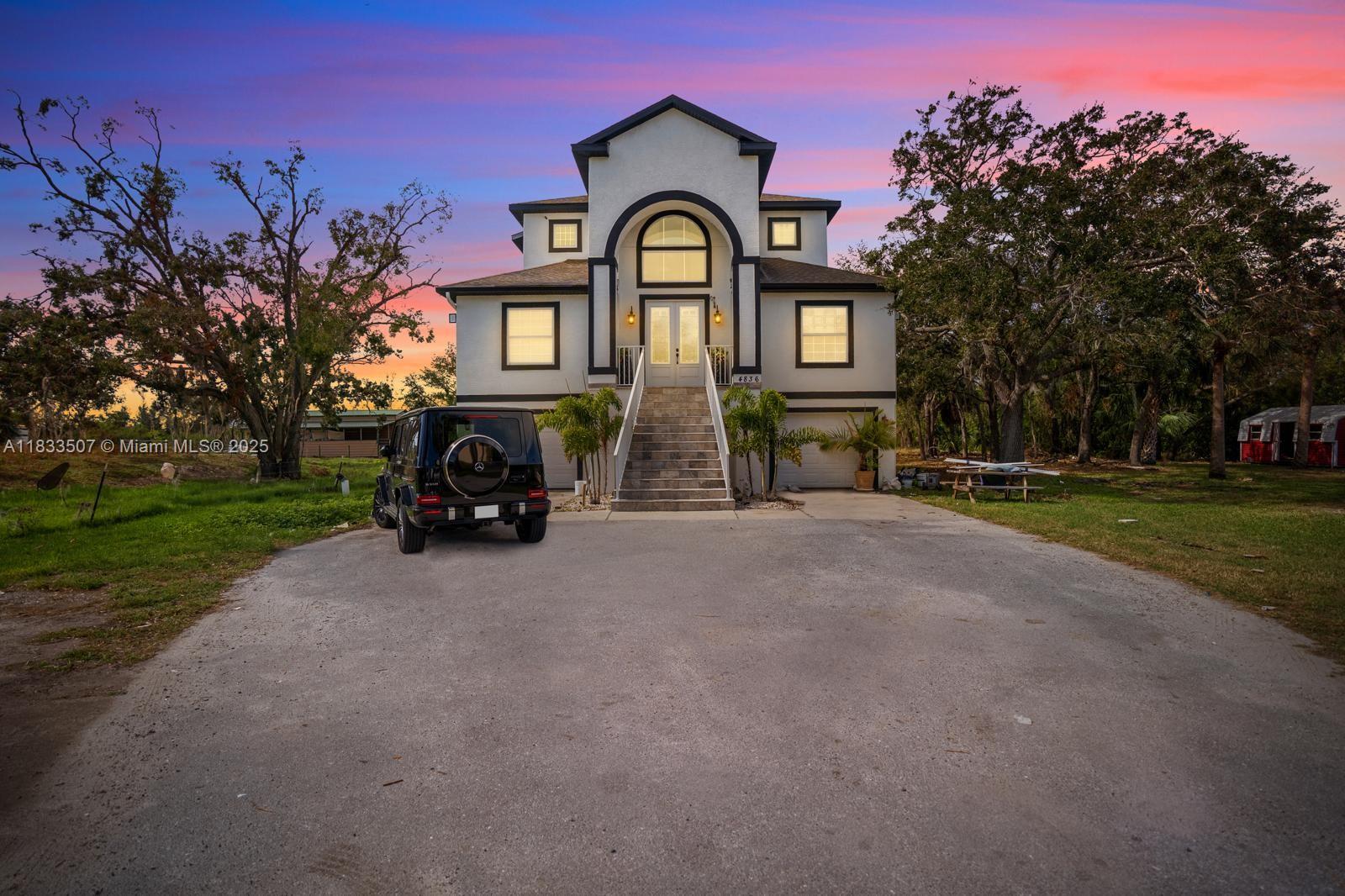 4836 Troydale Road Tampa, FL 33615 - Photo 1 of 52 a car parked in front of a house with a yard