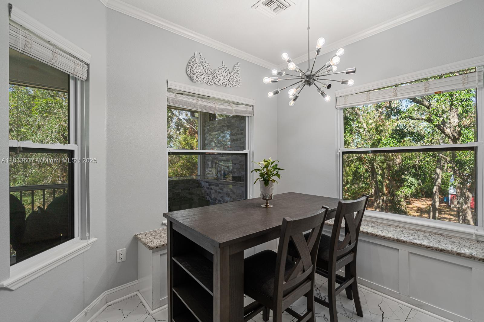 4836 Troydale Road Tampa, FL 33615 - Photo 16 of 52 a view of a dining room with furniture window and outside view