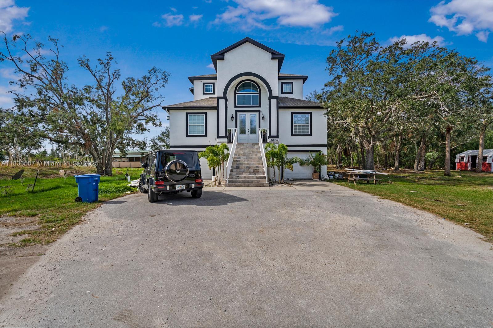 4836 Troydale Road Tampa, FL 33615 - Photo 2 of 52 a front view of a house with garden
