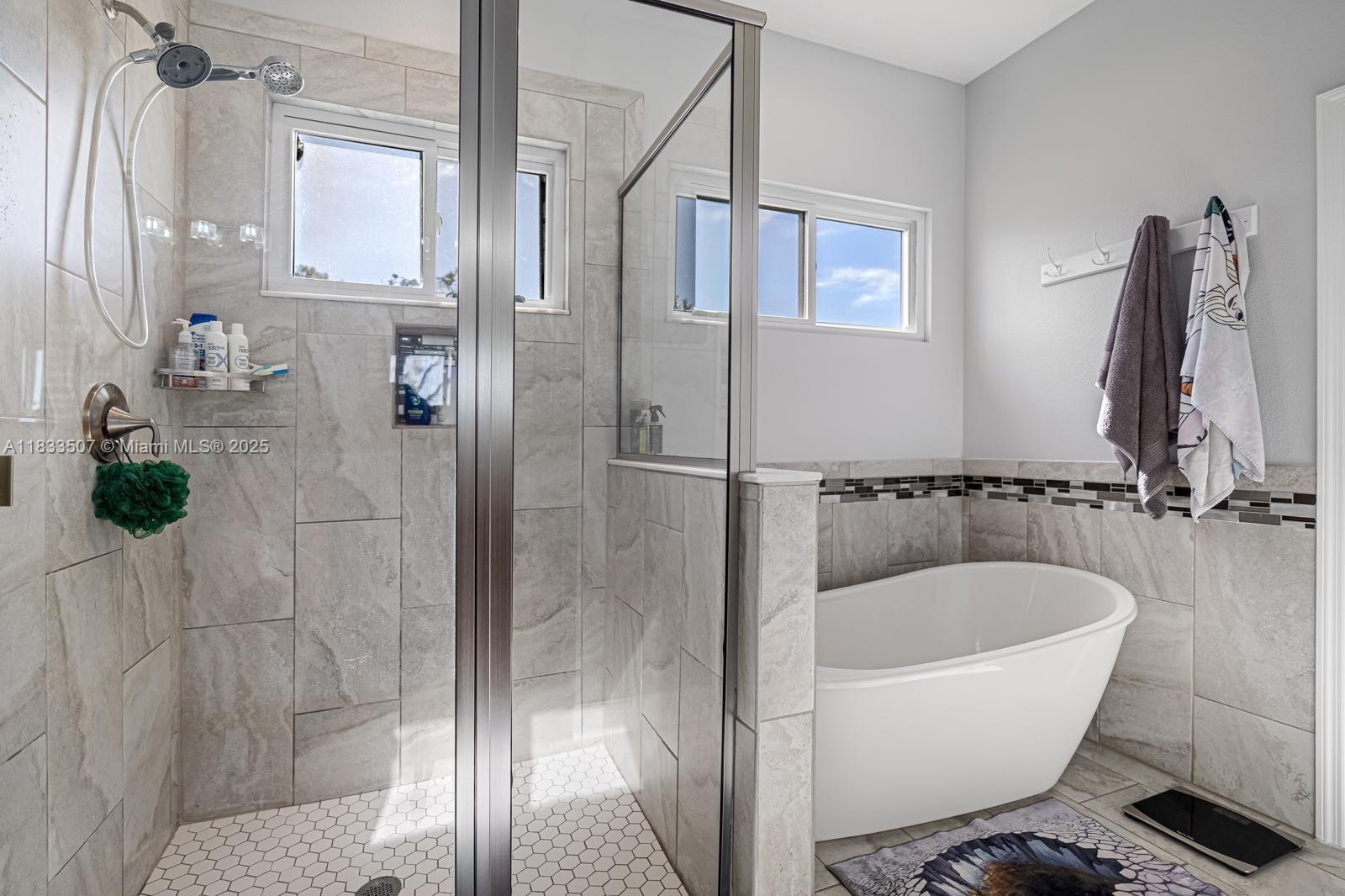4836 Troydale Road Tampa, FL 33615 - Photo 31 of 52 a bathroom with a bathtub and a shower
