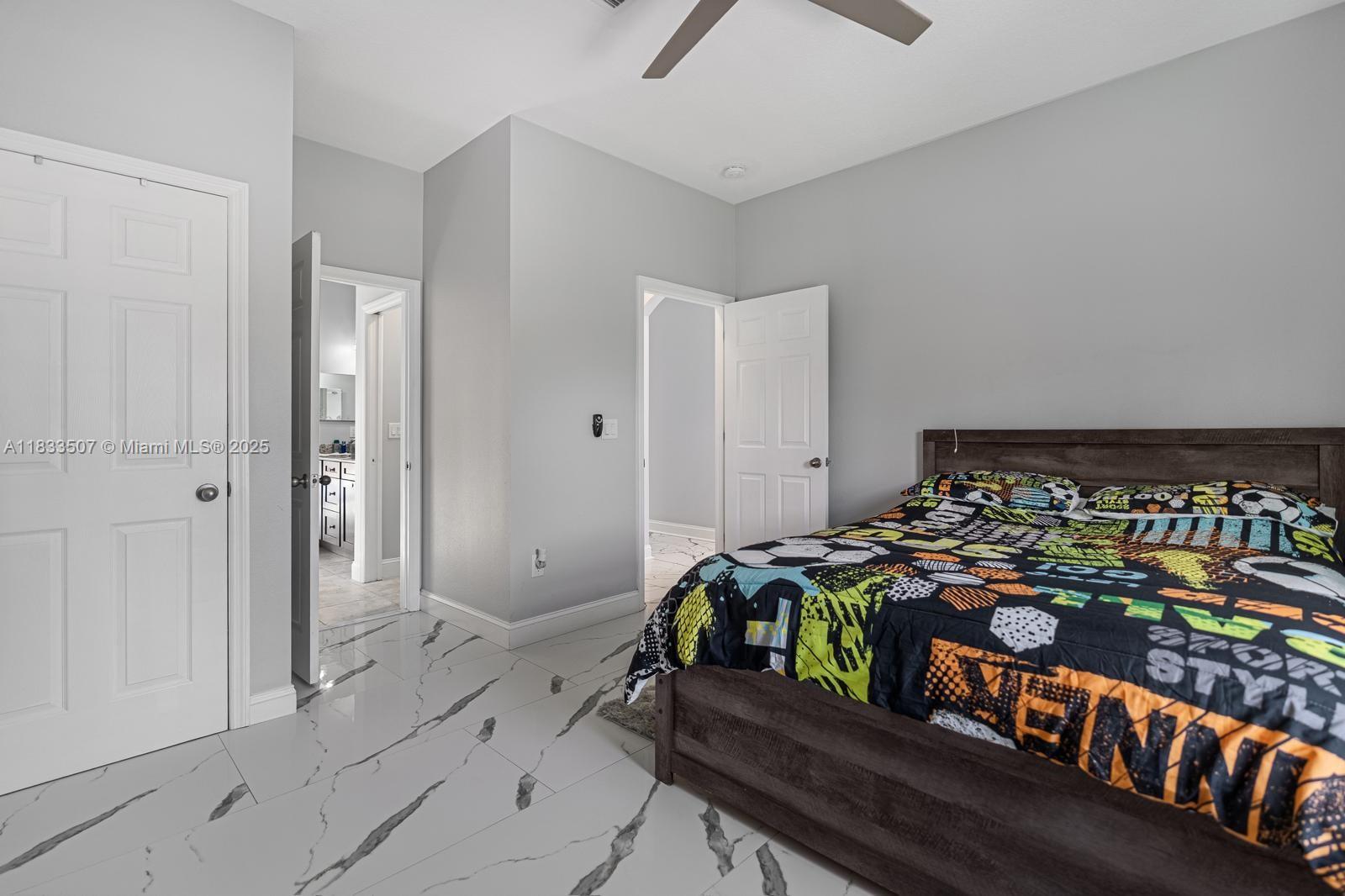 4836 Troydale Road Tampa, FL 33615 - Photo 32 of 52 a bedroom with bed and a window