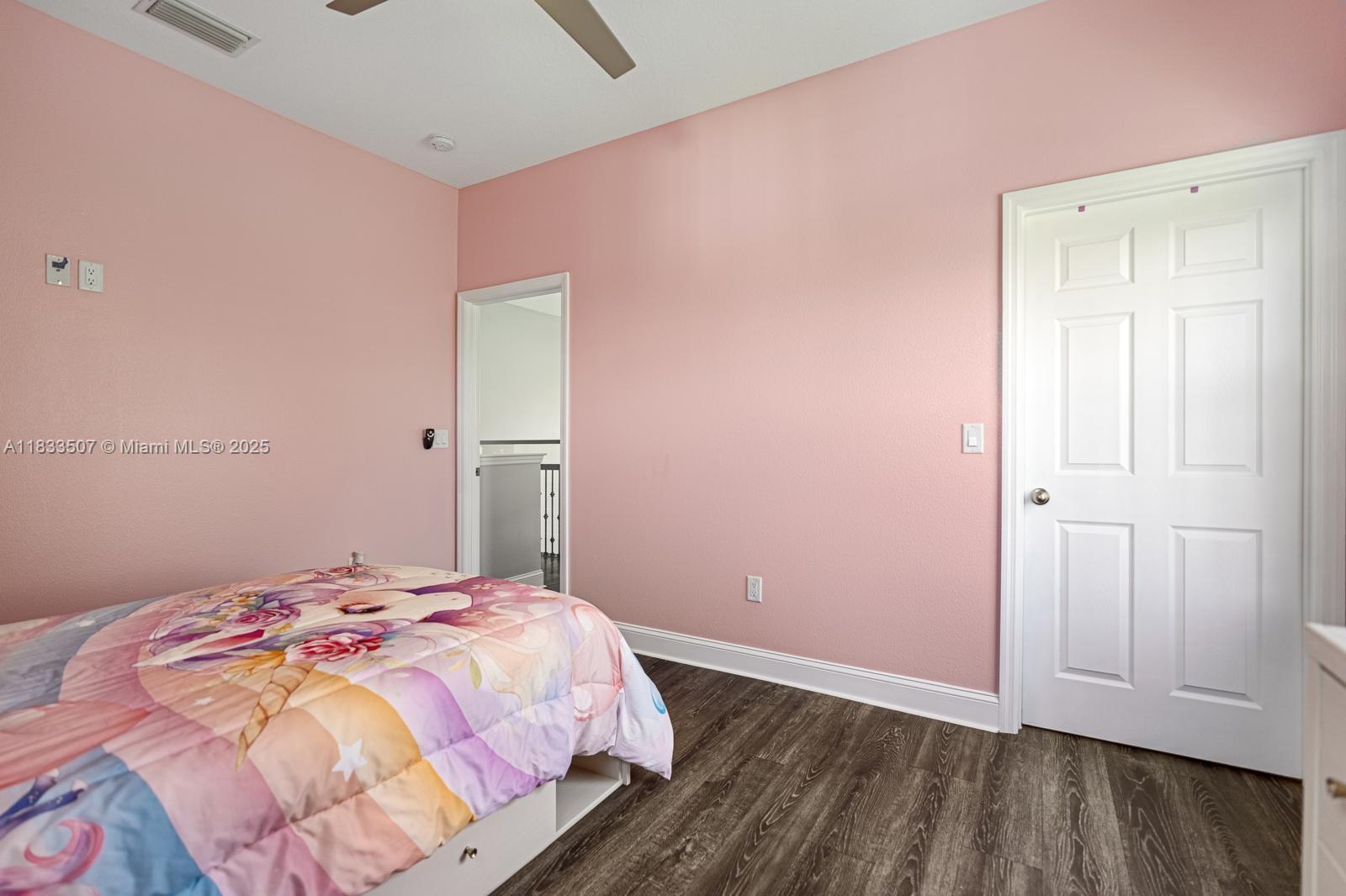 4836 Troydale Road Tampa, FL 33615 - Photo 37 of 52 a bedroom with a bed and wooden floor