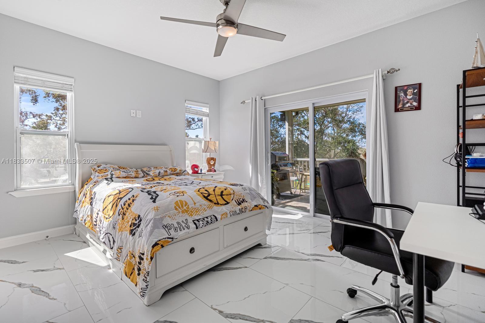 4836 Troydale Road Tampa, FL 33615 - Photo 39 of 52 a bed sitting in a bedroom next to a window