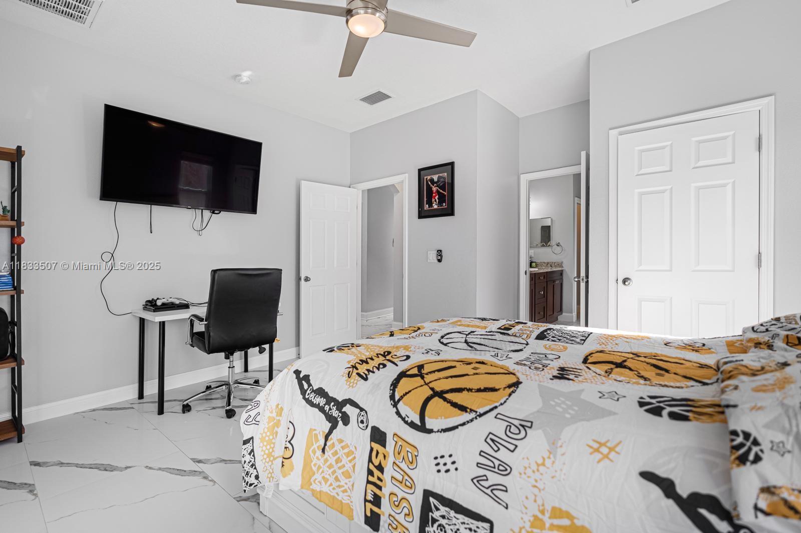 4836 Troydale Road Tampa, FL 33615 - Photo 40 of 52 a bedroom with a bed and a flat screen tv