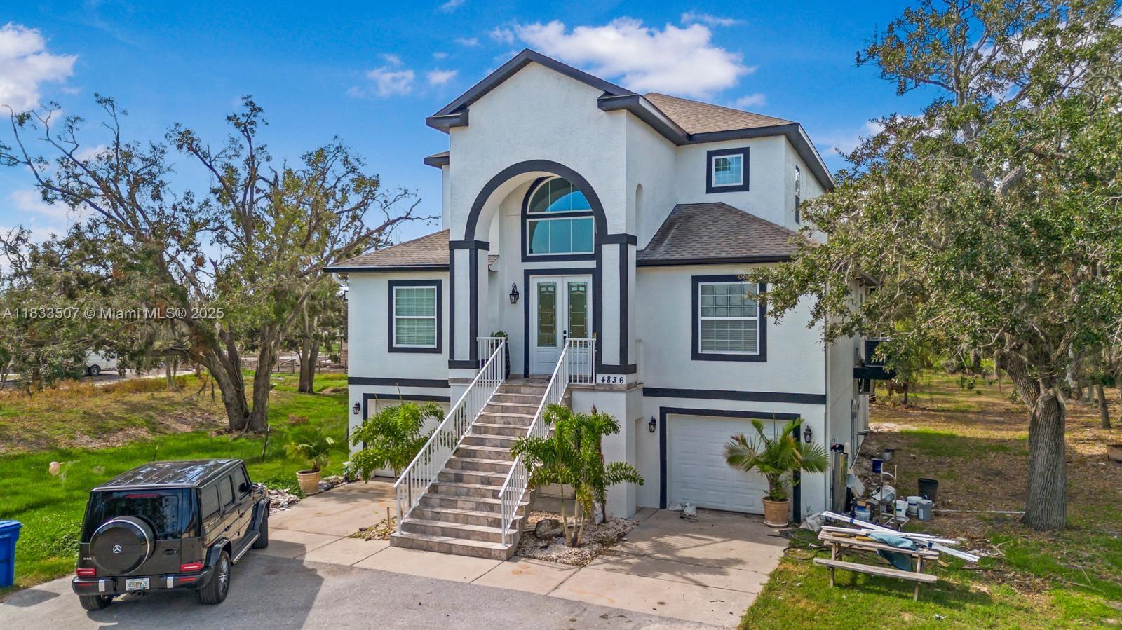4836 Troydale Road Tampa, FL 33615 - Photo 4 of 52 a front view of a house with garden