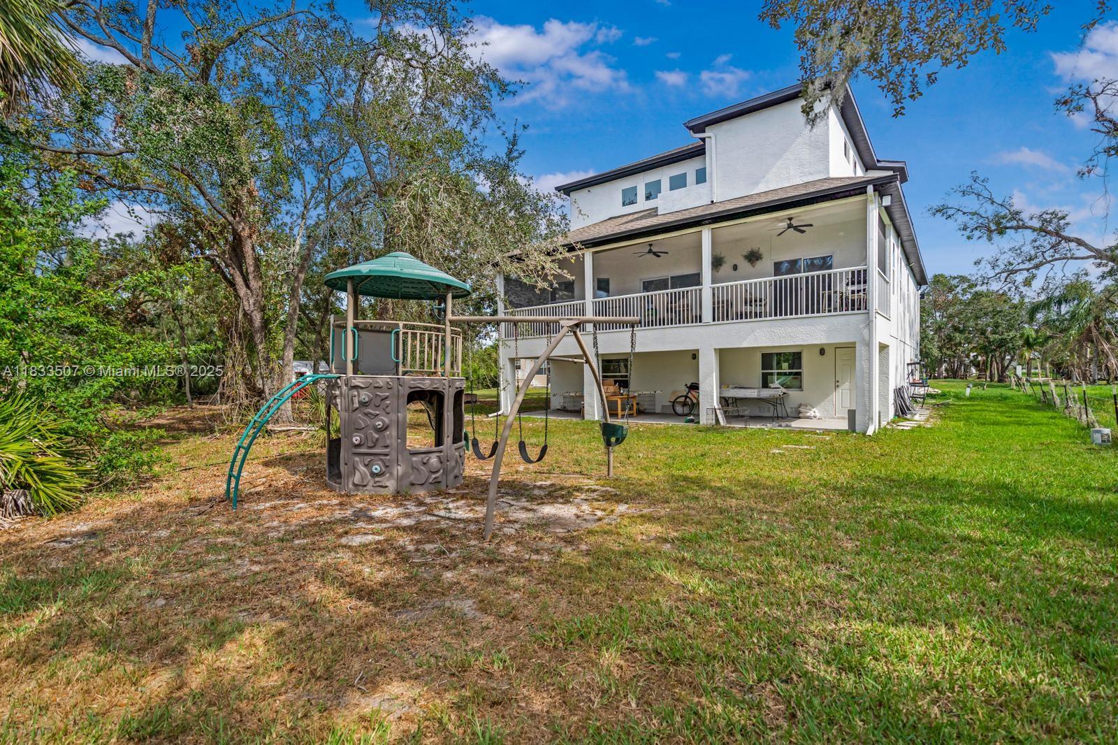 4836 Troydale Road Tampa, FL 33615 - Photo 47 of 52 a view of a house with a yard porch and sitting area