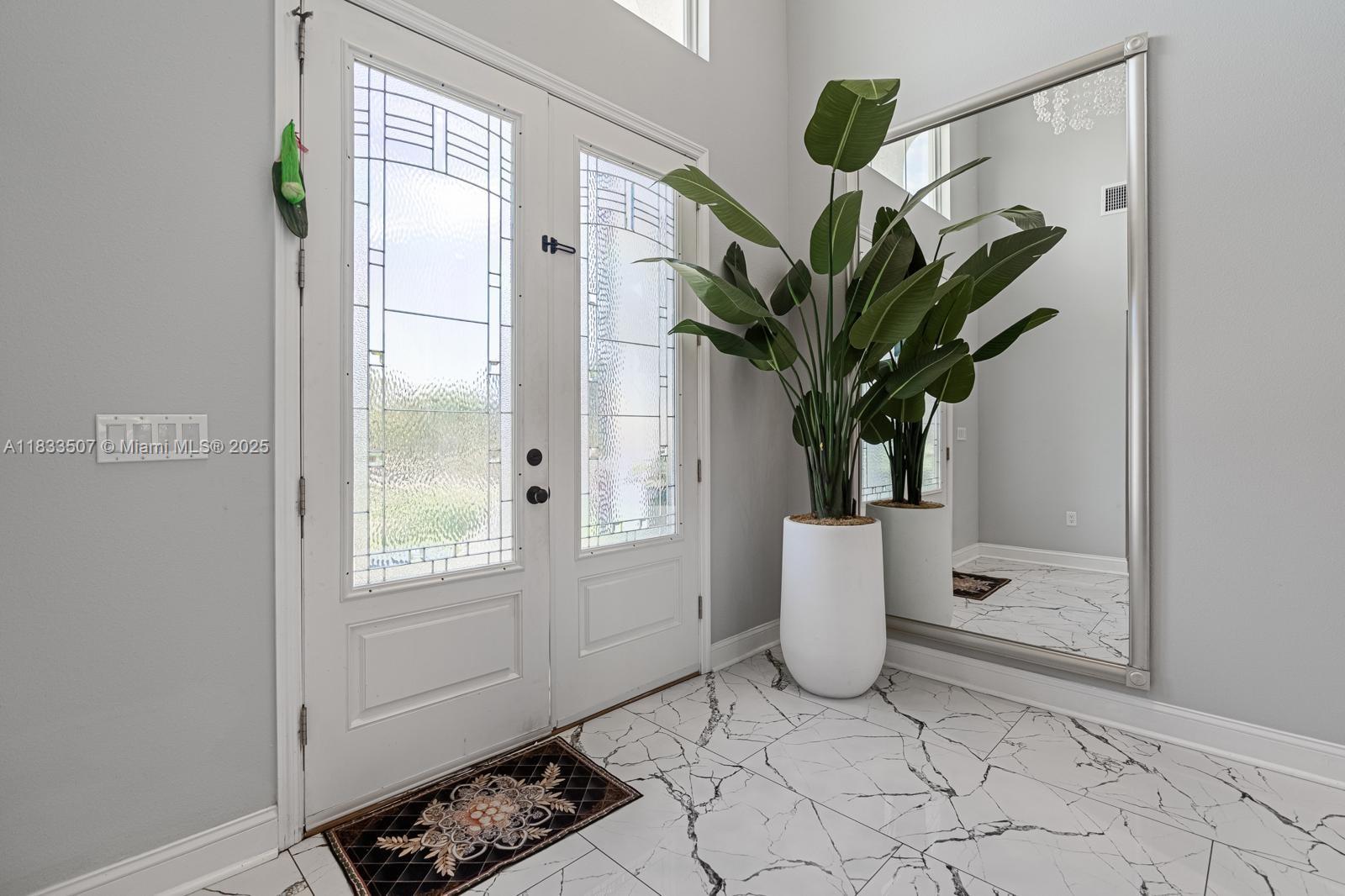 4836 Troydale Road Tampa, FL 33615 - Photo 6 of 52 a white vase with white and yellow flowers