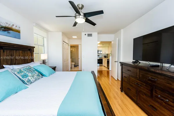 a bed room with a bed and a television