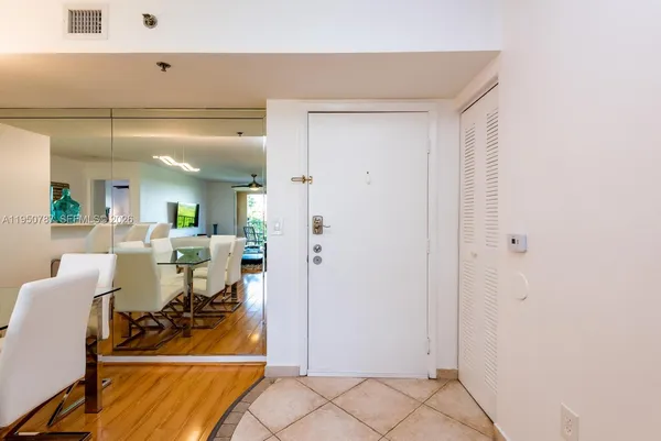 a living room with dining room and kitchen view