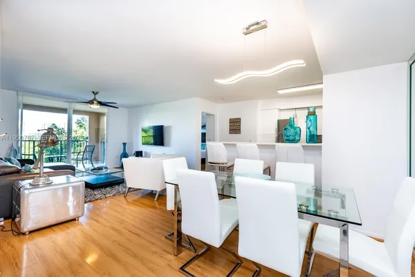 a living room with furniture a flat screen tv and a large window