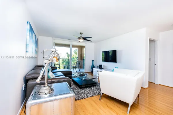 a living room with furniture large window and a flat screen tv