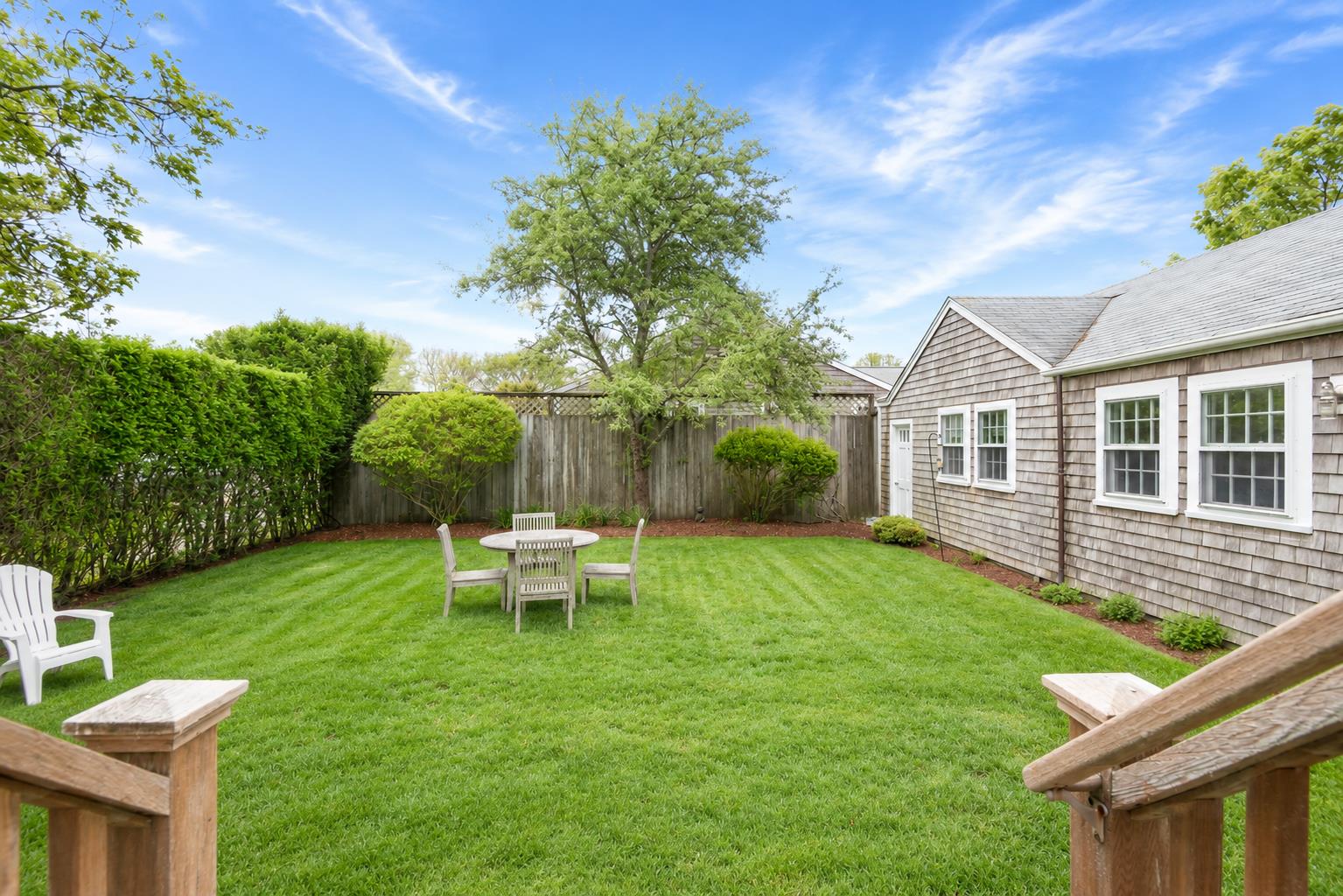 12 King Street Nantucket, MA 02554 - Photo 31 of 32 a view of a house with backyard sitting area and garden