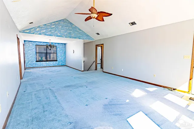 a view of a livingroom with a ceiling fan and window