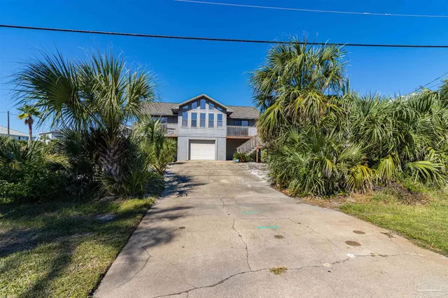 a view of a balcony with wooden floor and outdoor seating
