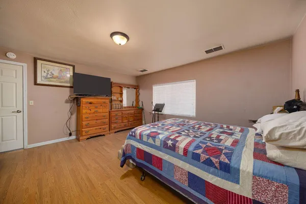 a bedroom with a bed and dresser