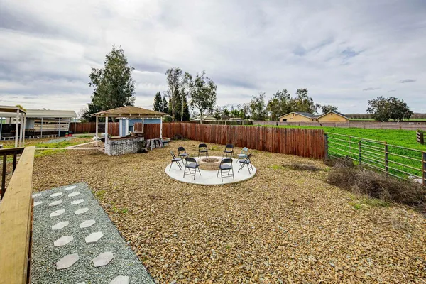 a view of a house with backyard and sitting area