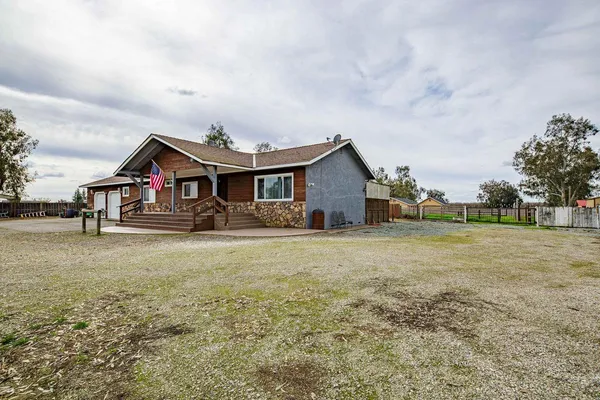 a front view of house with yard and entertaining space