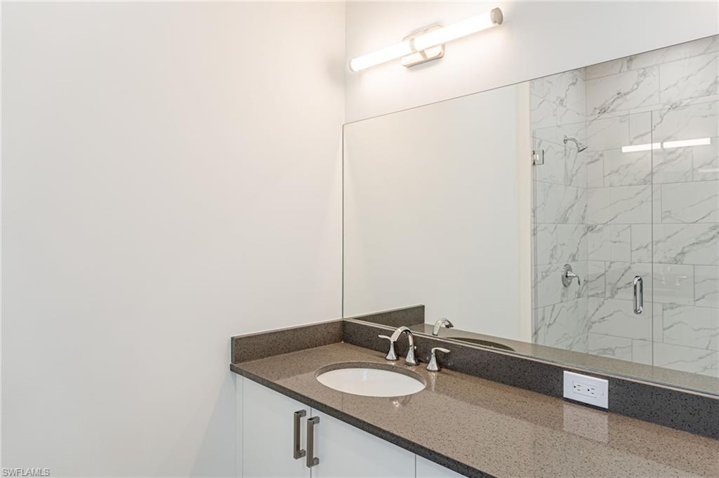5816 Shell Cove Drive Cape Coral, FL 33914 - Photo 12 of 16 Full bath featuring vanity and a marble finish shower
