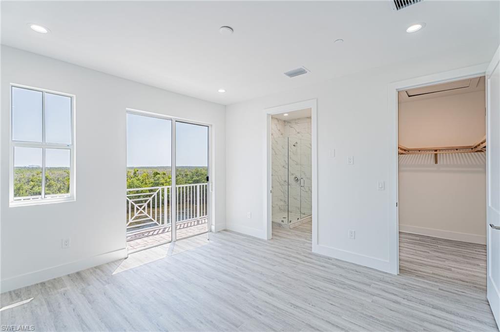 5816 Shell Cove Drive Cape Coral, FL 33914 - Photo 14 of 16 Unfurnished bedroom with access to exterior, a walk in closet, light wood-type flooring, and recessed lighting