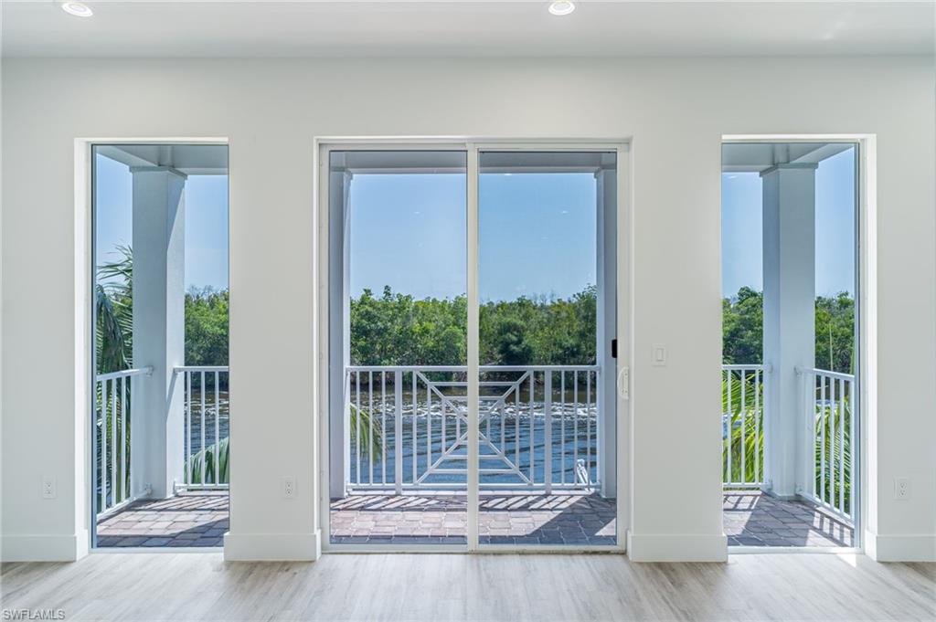 5816 Shell Cove Drive Cape Coral, FL 33914 - Photo 6 of 16 Doorway featuring wood finished floors and recessed lighting