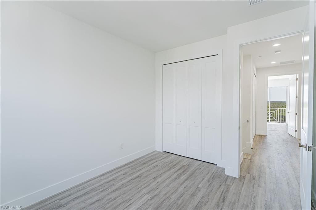 5816 Shell Cove Drive Cape Coral, FL 33914 - Photo 9 of 16 Unfurnished bedroom featuring wood finished floors, a closet, and recessed lighting