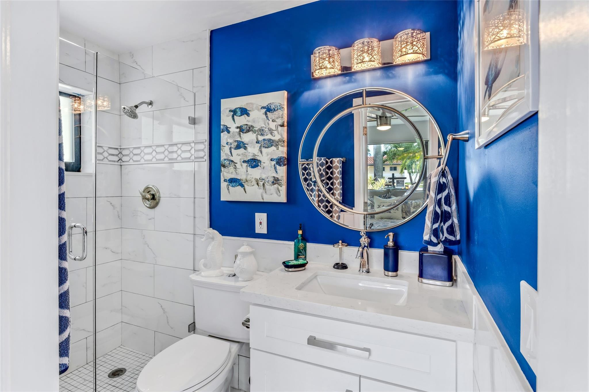 2541 Northeast 48th Street Lighthouse Point, FL 33064 - Photo 15 of 31 a bathroom with a sink a toilet and a mirror