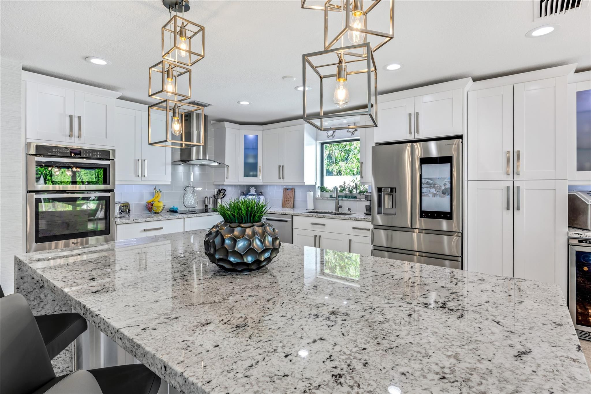 2541 Northeast 48th Street Lighthouse Point, FL 33064 - Photo 7 of 31 a kitchen with stainless steel appliances granite countertop a sink a stove and a refrigerator