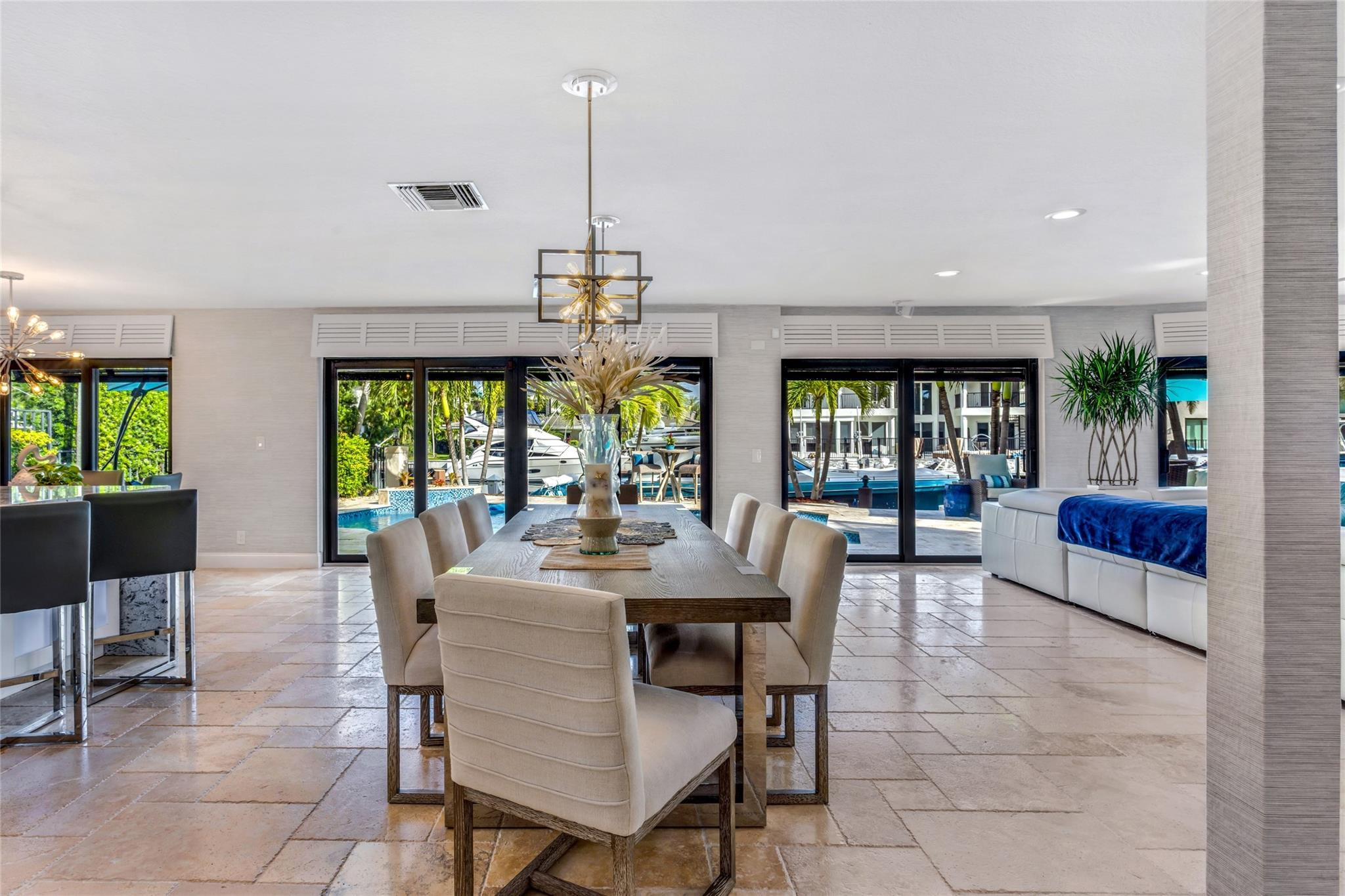 2541 Northeast 48th Street Lighthouse Point, FL 33064 - Photo 10 of 31 a view of a dining room and livingroom with furniture wooden floor a chandelier