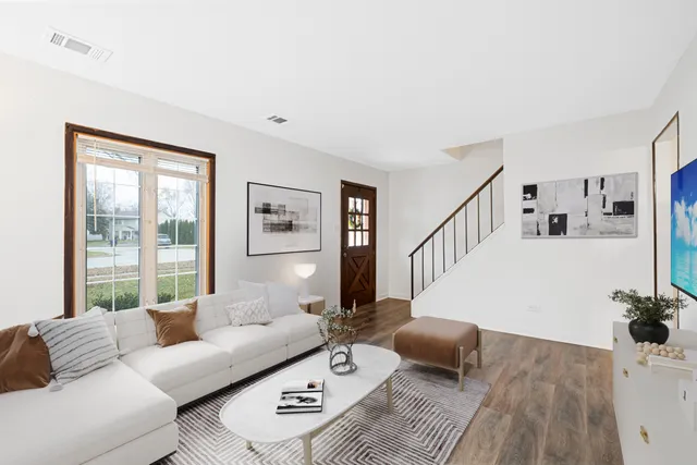 a living room with furniture and wooden floor