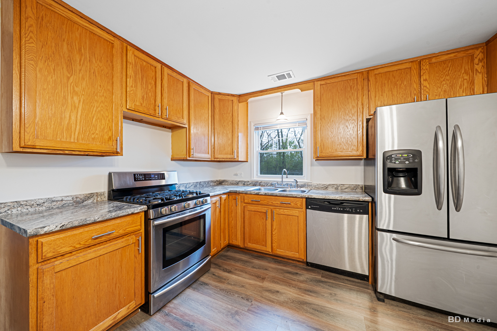 5503 Georgetown Drive Matteson, IL 60443 - Photo 14 of 27 a kitchen with granite countertop a stove a sink dishwasher a refrigerator and wooden cabinets with wooden floor