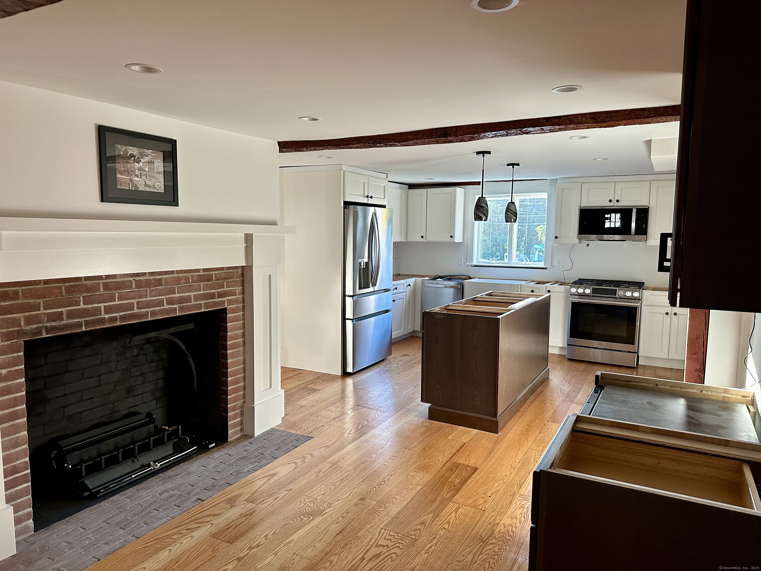 2318 Mill Plain Road Fairfield, CT 06824 - Photo 4 of 14 a kitchen with stainless steel appliances granite countertop a stove top oven and sink